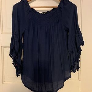 Pretty top with pom pom fringe on sleeves